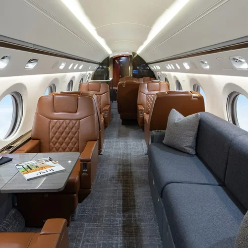 Luxury private jet interior design with leather seating, lounge sofa, and tailored finishes