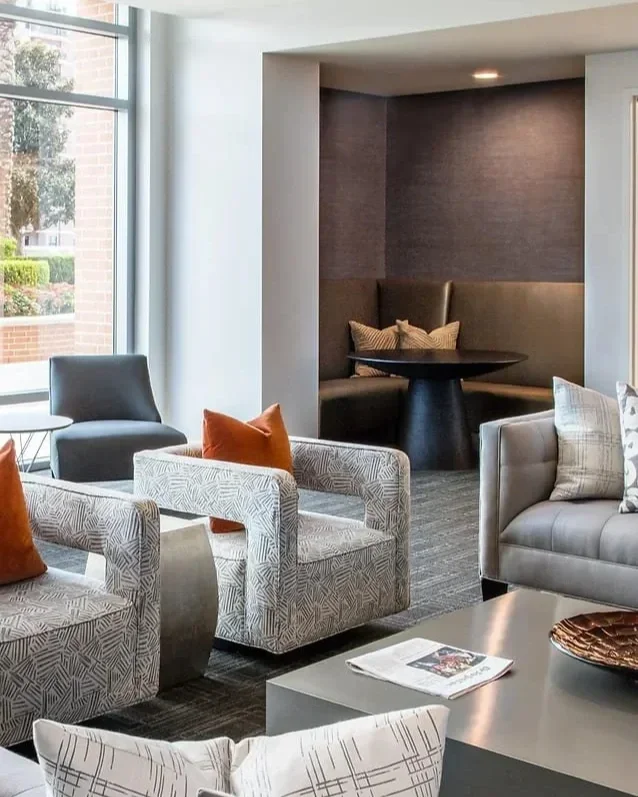 Modern luxury condominium interior design at Highland Tower Houston featuring tailored lounge seating, warm accent tones, and refined contemporary finishes.