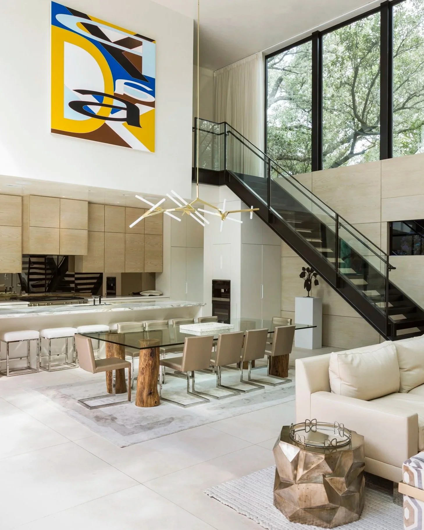 Luxury dining room interior design in Houston featuring dramatic wall mural, brass details, and custom cabinetry at Stanmore.