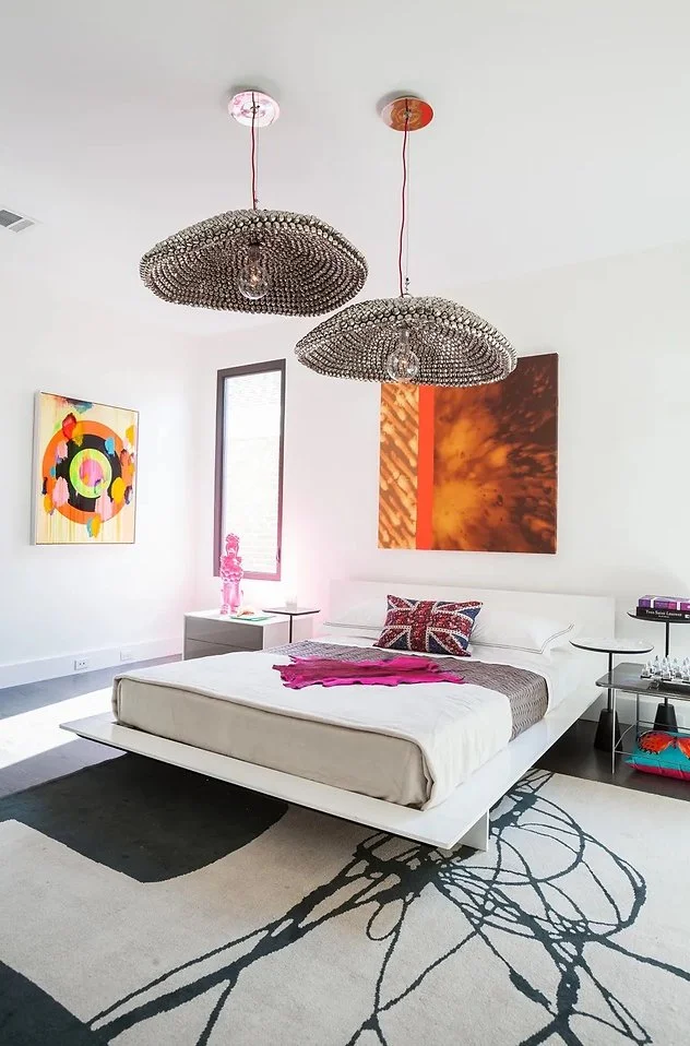 Modern bedroom with abstract art and unique lighting