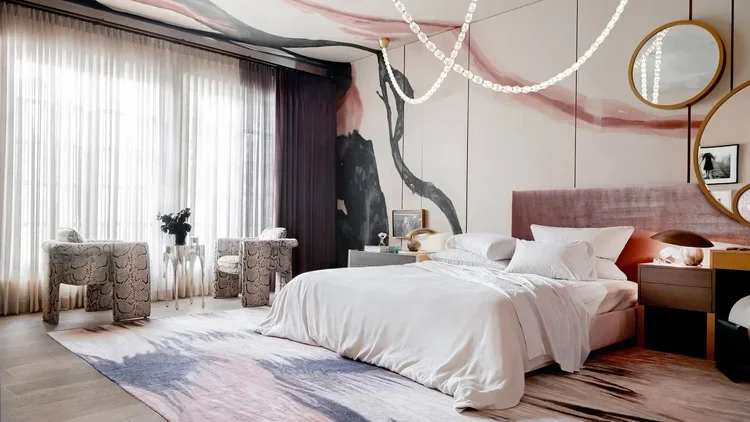 Luxury interior design bedroom with mural wall treatment, upholstered headboard, and bespoke lighting at Kips Bay Dallas