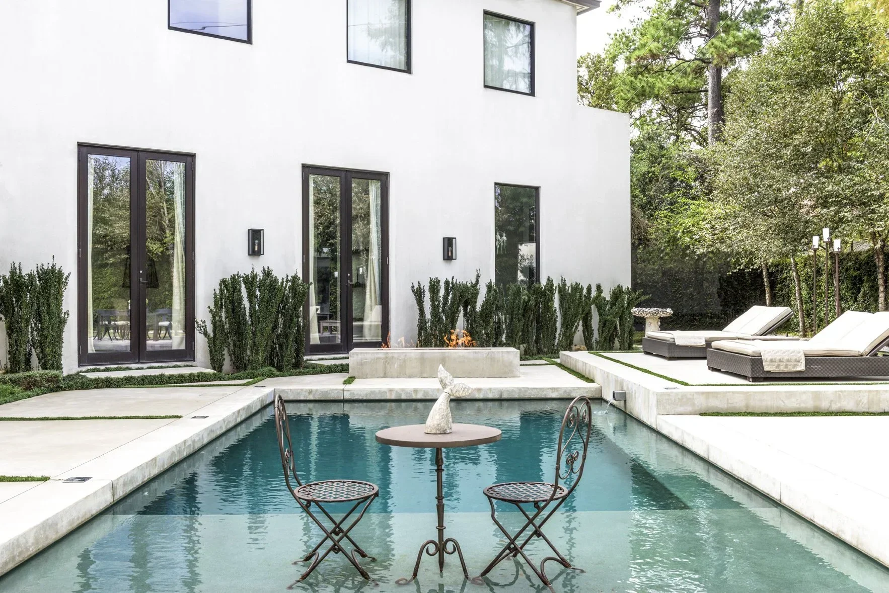 Luxury residential outdoor living space with pool courtyard, clean architectural lines, and tailored landscaping