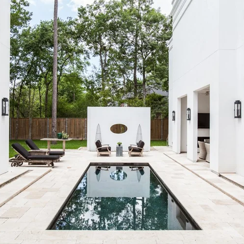 Luxury residential design in Houston with a minimalist pool courtyard and outdoor entertaining area
