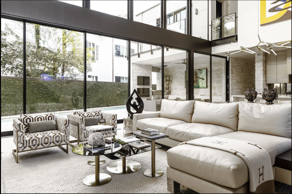 Custom home interior design Houston modern residence with floor to ceiling glazing and tailored seating