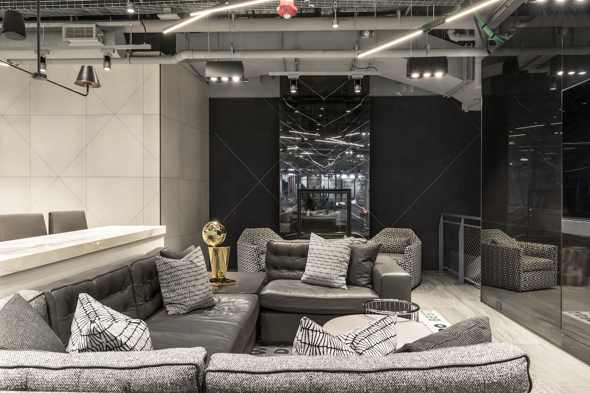 Office lounge in Montrose Neartown Houston with monochrome finishes, layered seating, and a sleek contemporary commercial interior design aesthetic.