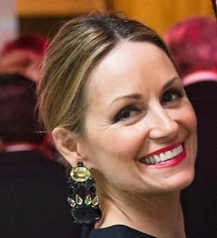 Smiling woman with elegant earrings at an event