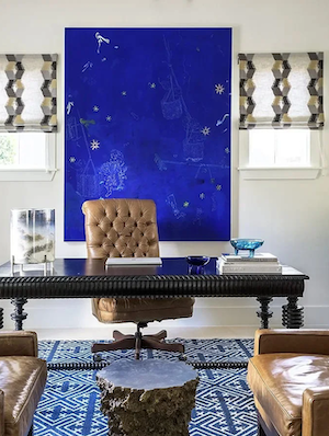 Full service interior design home office in Houston with bold blue artwork, leather seating, and layered textures