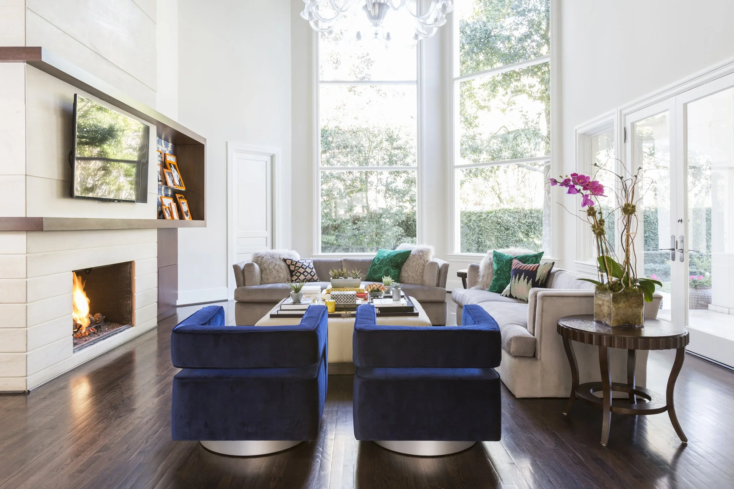 Luxury residential interior design in a double-height living space with contemporary architecture, statement art, and open-plan entertaining areas