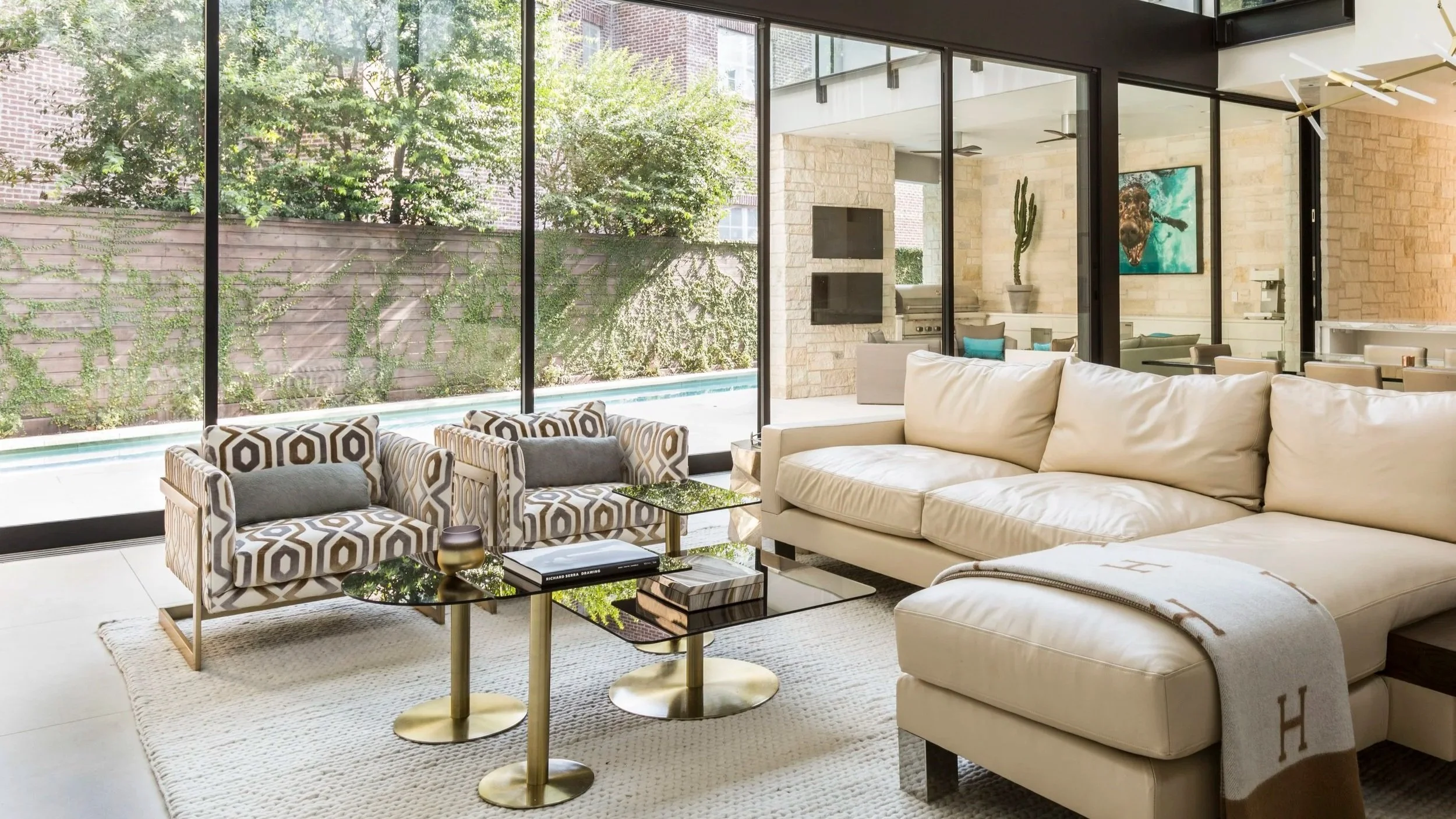 Luxury living room interior design in Houston featuring classical panel detailing, curated art, and tailored contemporary furnishings at Stanmore.