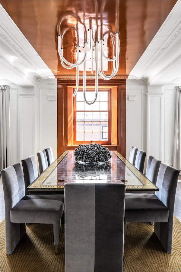 Luxury residential interior design living room with fireplace, tall windows, layered seating, and a polished full-service finish