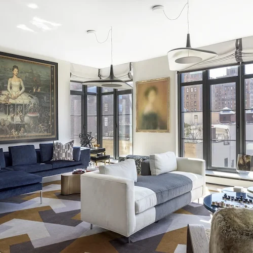 Full service interior design for a luxury NYC apartment living room in Chelsea with custom seating and large-scale art